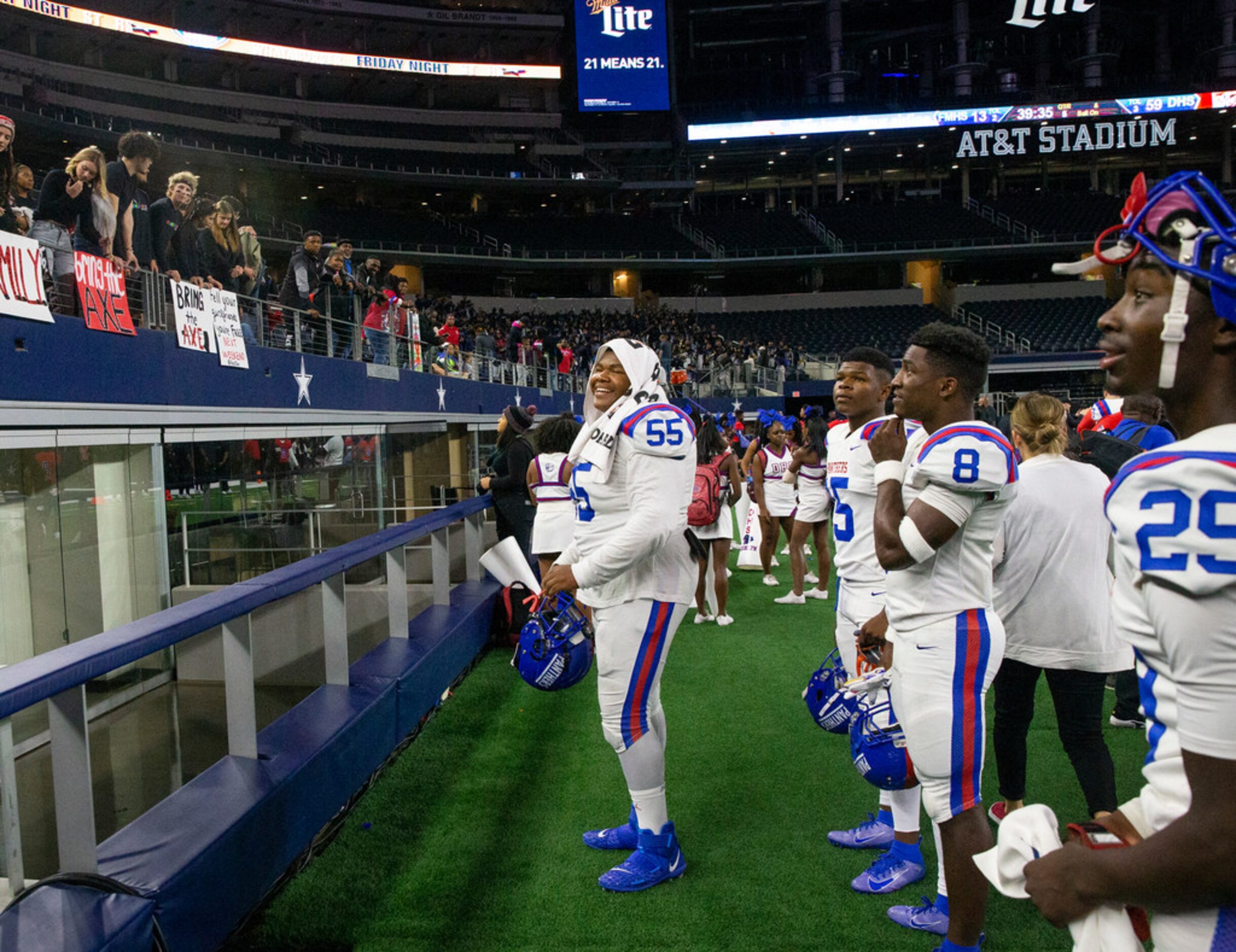 Duncanville offensive lineman Joshua Qualls (55) celebrates with fans in the stands after...