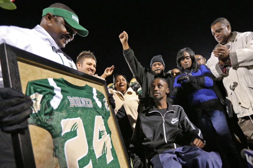 Family and friends surrounded Corey Borner at Eagle Stadium during a halftime ceremony as...