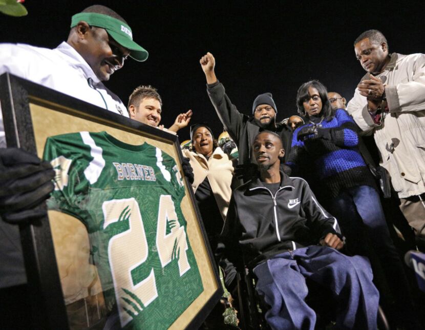 Family and friends surrounded Corey Borner at Eagle Stadium during a halftime ceremony as...