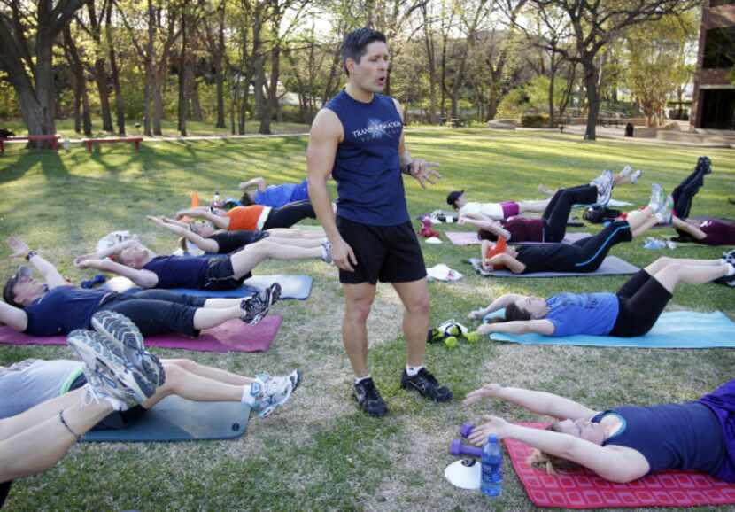 Personal trainer Mike Thornton runs his Transformation Boot Camp outside in the heat. He ...