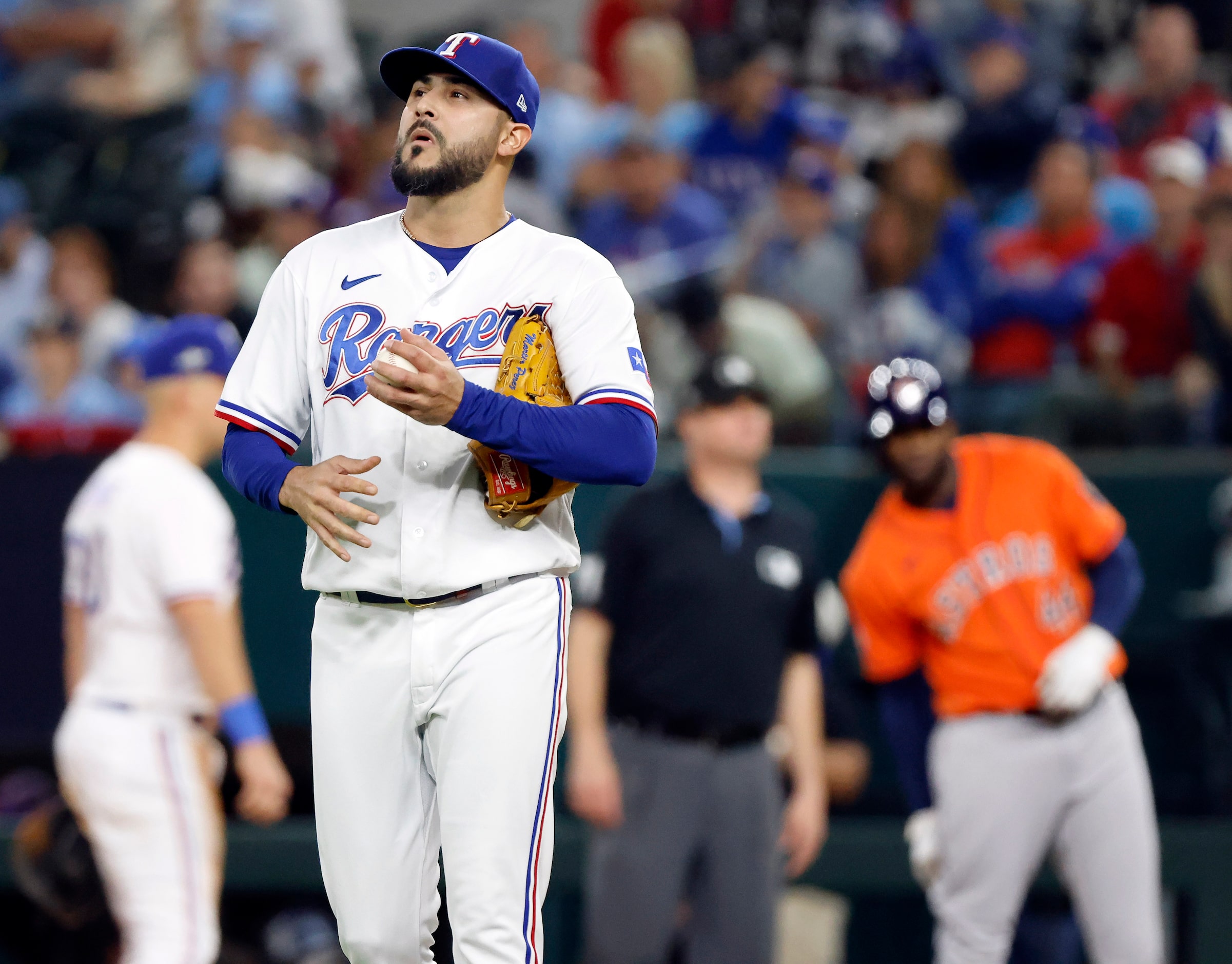 Texas Rangers starting pitcher Martin Perez (54) walks around the mound after walking...