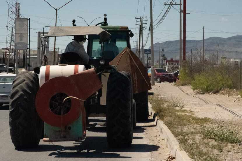 Tractors being led and followed by police vehicles sprayed the grounds Tuesday around the...