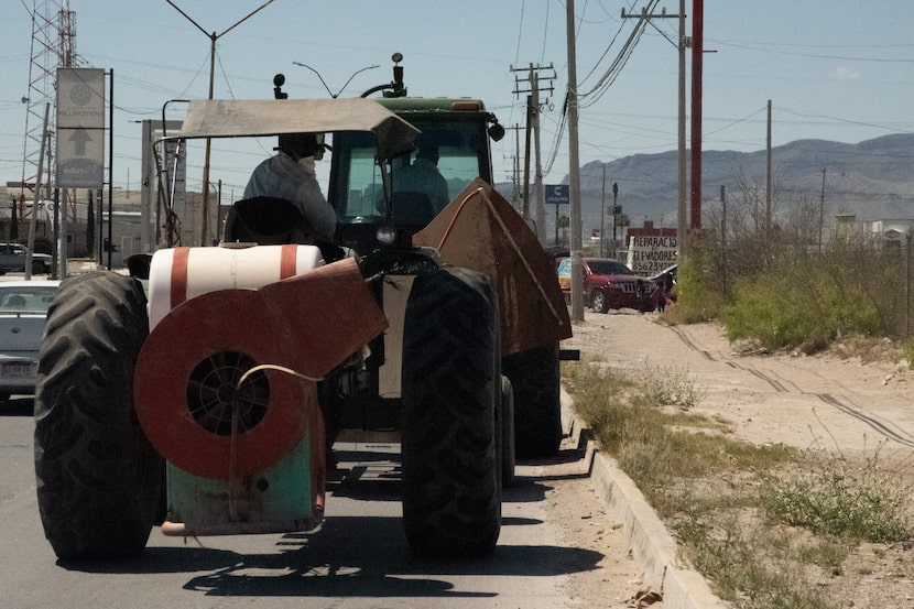 Tractors being led and followed by police vehicles sprayed the grounds Tuesday around the...