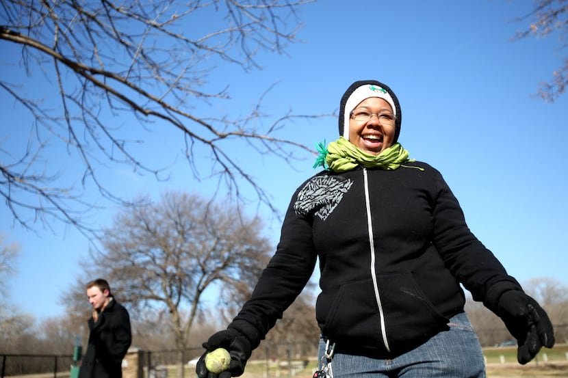 Jonisha Ash plays with her dog at White Rock Lake Dog Park on a cold winter day in Dallas. 