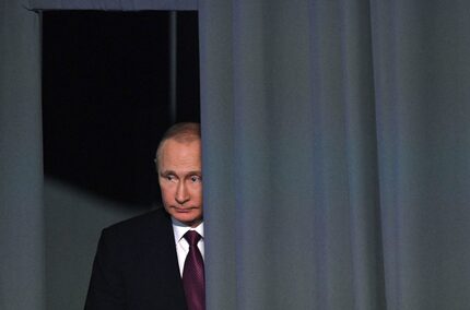 Russian President Vladimir Putin enters a hall before his annual press conference in Moscow...