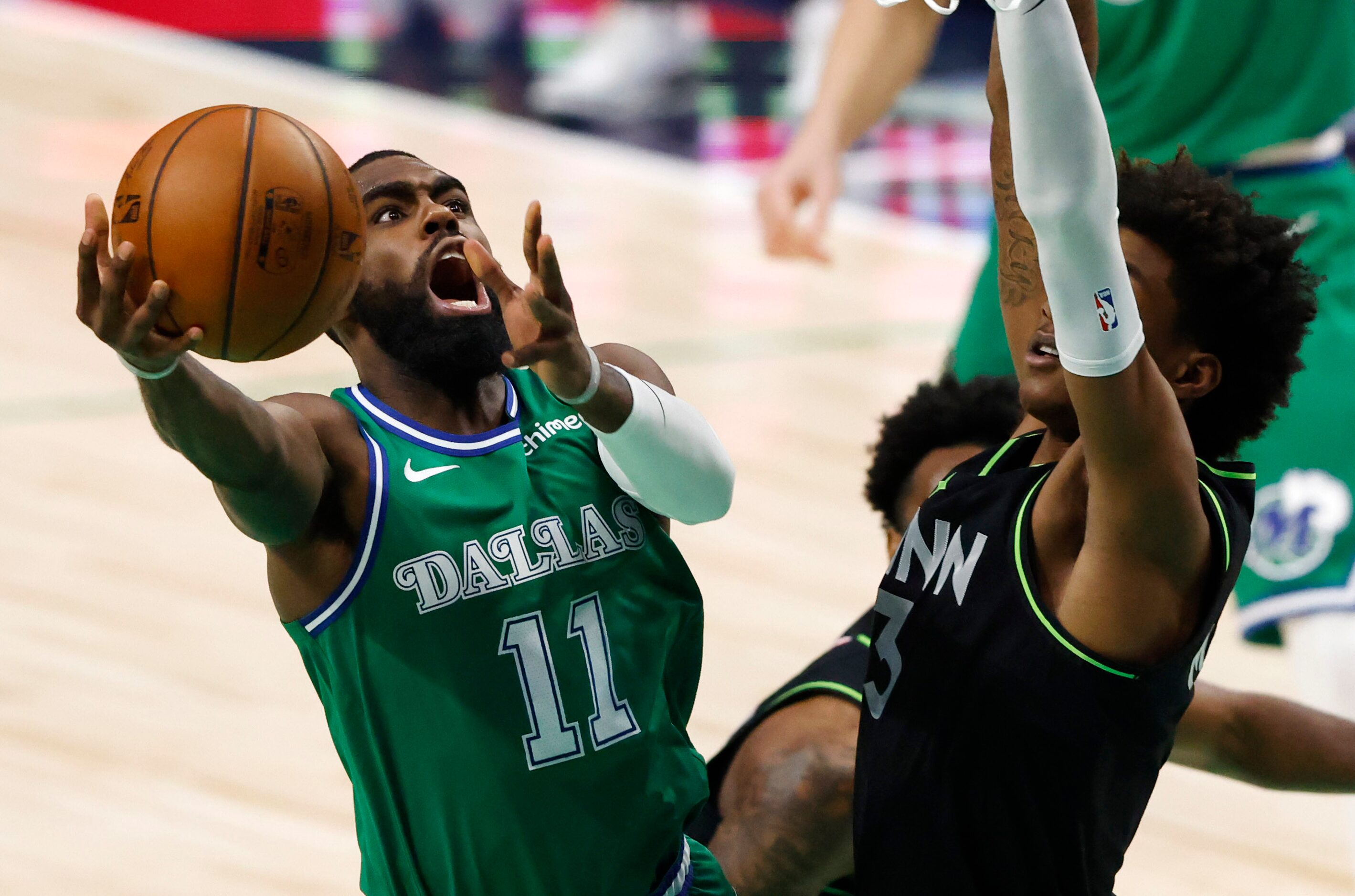 Dallas Mavericks guard Tim Hardaway Jr. (11) attempts a shot in front of Minnesota...