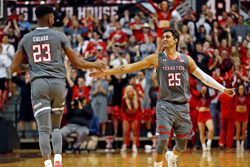 Texas Tech's Davide Moretti (25) high-fives Jarrett Culver (23) after he scored a...