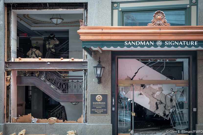 Fort Worth firefighters examine the damage inside the Sandman Signature Hotel in downtown...
