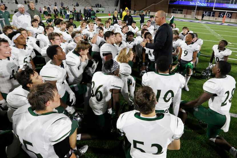 Prosper head coach Brandon Schmidt talks with his players on the field after their 42-37 win...