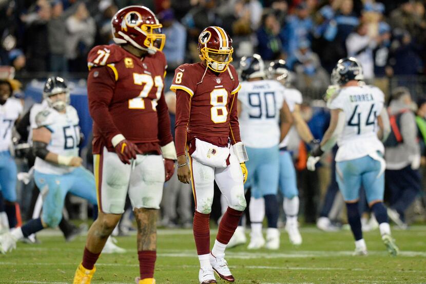 Washington Redskins quarterback Josh Johnson (8) walks off the field after throwing an...