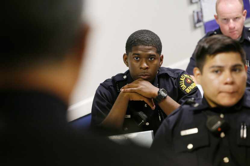 Justin Milton (center) relates to other Dallas police recruits the story of his grandmother...