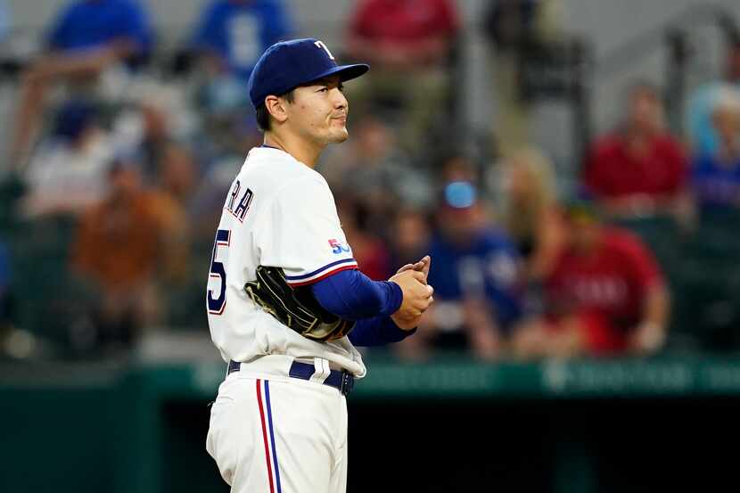 Texas Rangers starting pitcher Kohei Arihara stands on the mound waiting to be pulled in the...