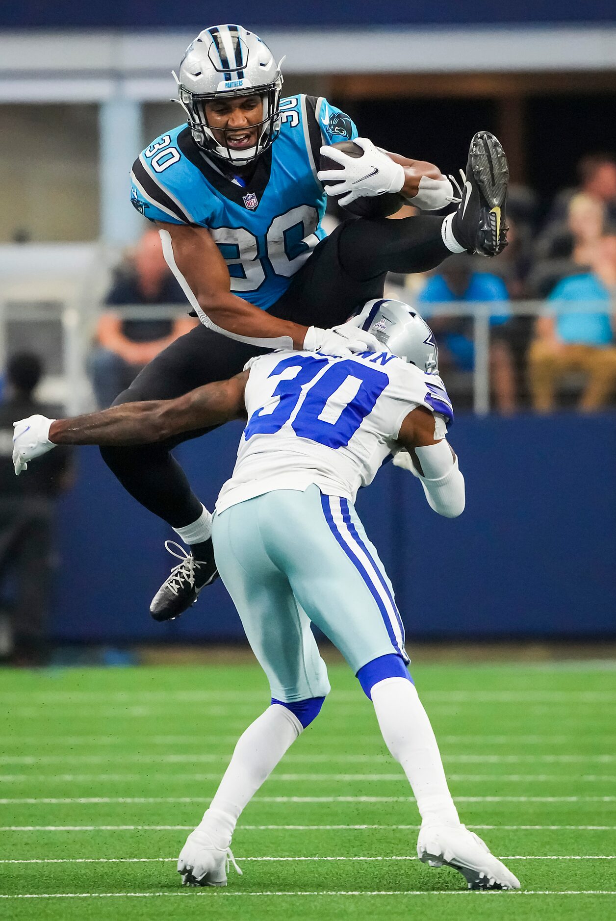 Carolina Panthers running back Chuba Hubbard  tries to hurdle Dallas Cowboys cornerback...