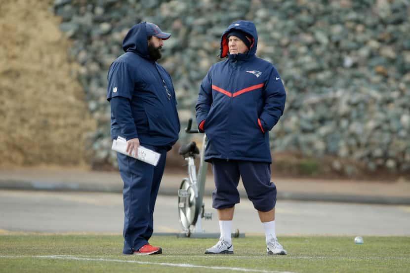 New England Patriots defensive coordinator Matt Patricia, left, speaks with  head coach Bill...