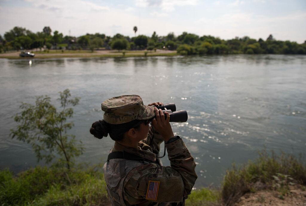 A file photo shows a Texas National Guard soldier watching over the Rio Grande in Starr...