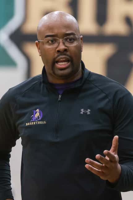 Denton High School’s head coach Michael Thomas talks to his team during a game at Birdville...