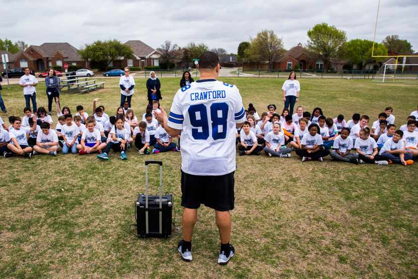 Dallas Cowboys defensive lineman Tyrone Crawford answers questions from students before...