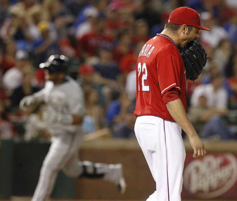 Texas Rangers starting pitcher Matt Garza (22) reacts after Milwaukee Brewers first baseman...