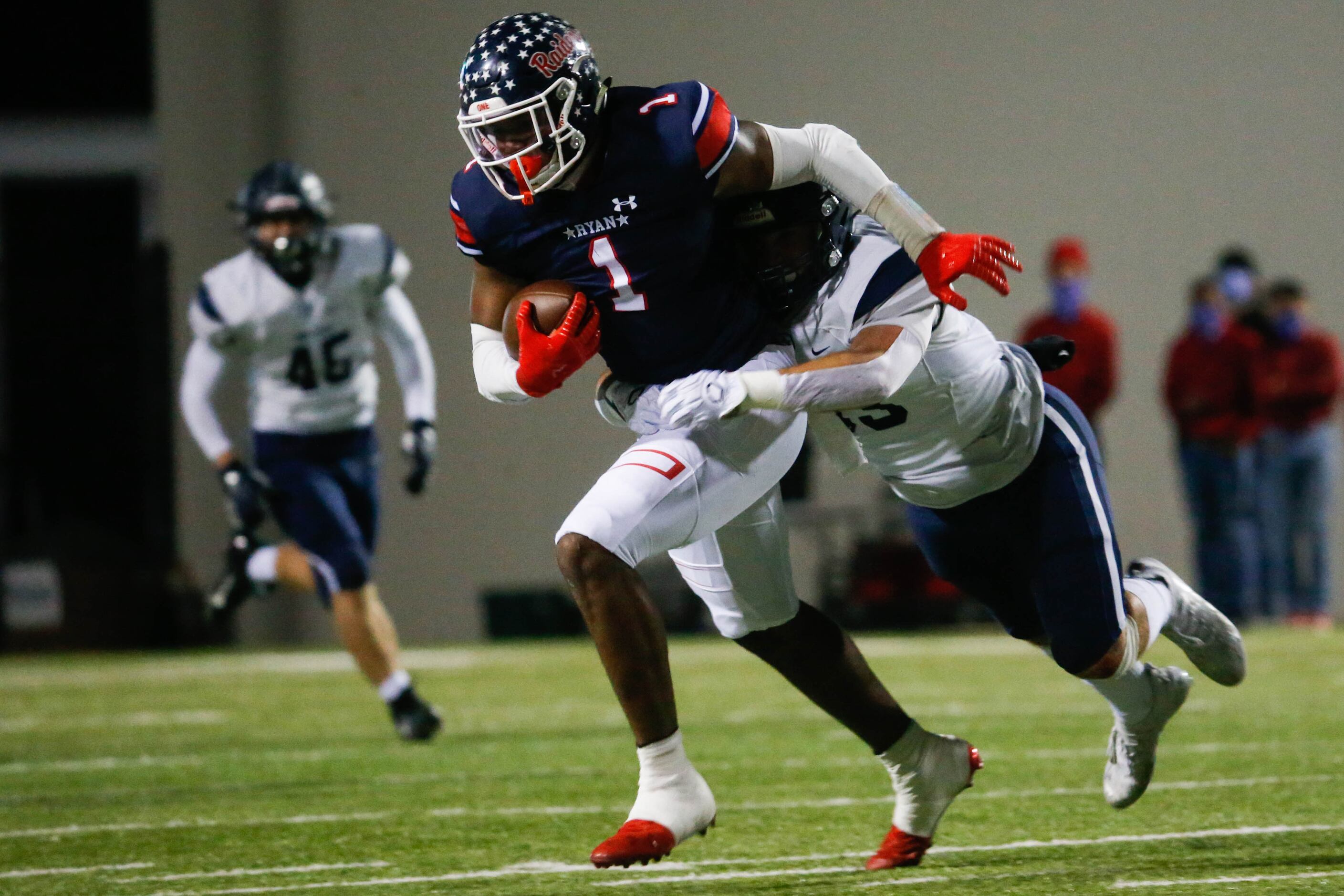 Denton Ryan's Ja'tavion Sanders (1) is tackled during the first half of a football game...