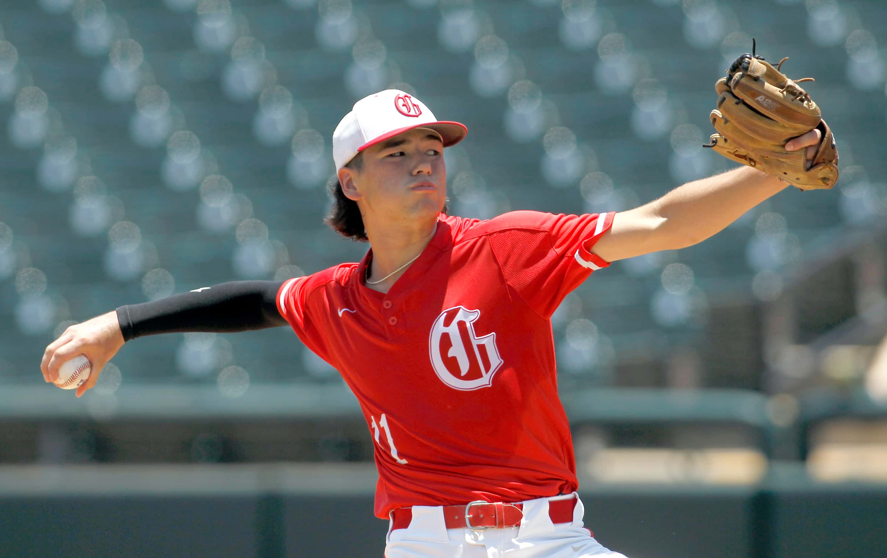 Grapevine pitcher JoJo Kubo (11) delivers a pitch to a Lovejoy batter during the top of the...