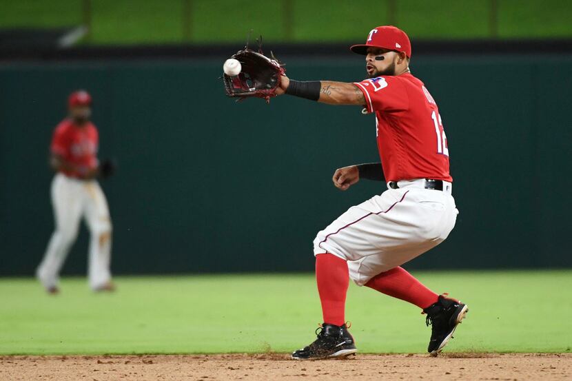 Texas Rangers second baseman Rougned Odor fields a grounder by Chicago White Sox's Charlie...