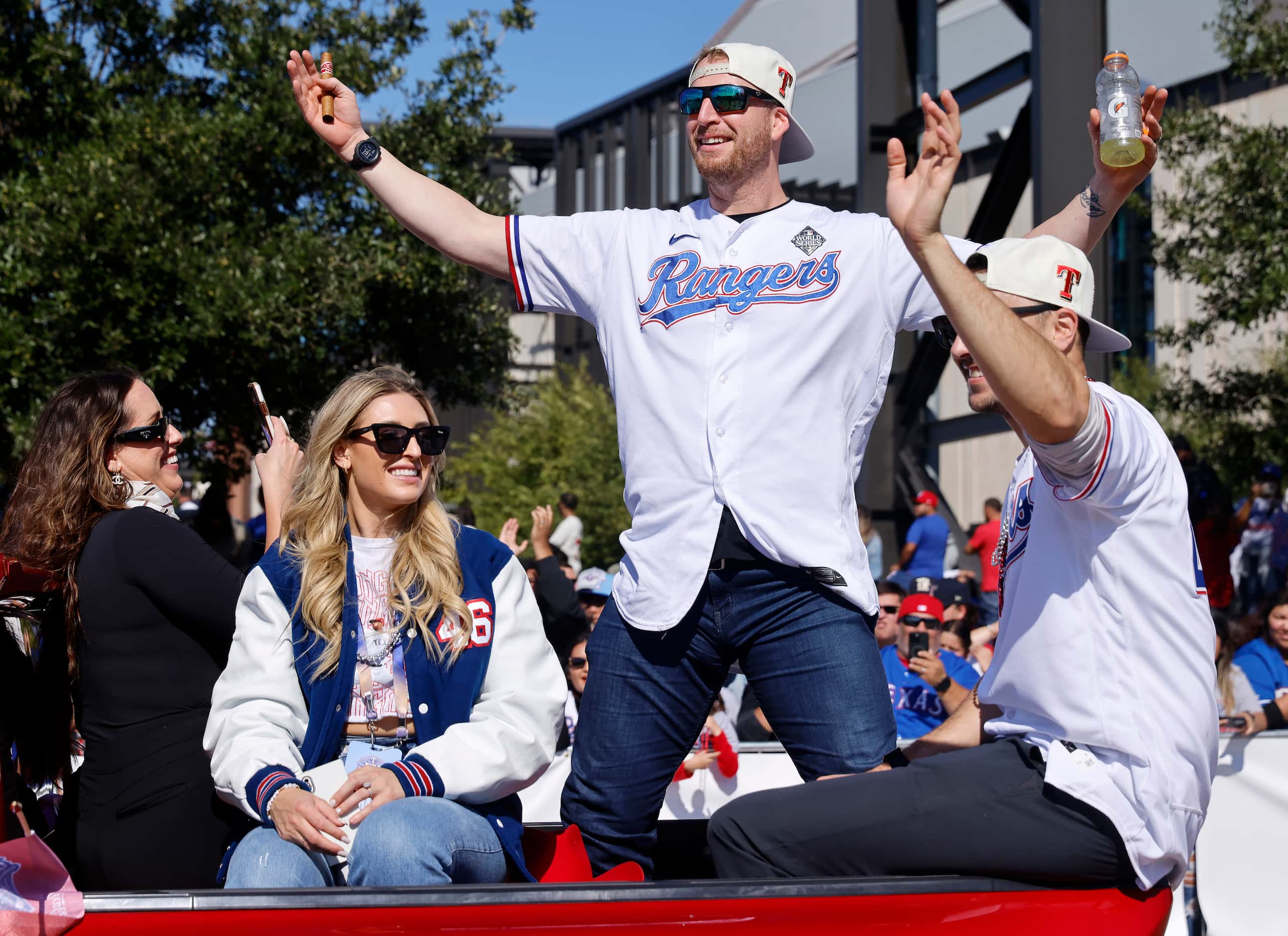 Texas Rangers pitcher Brock Burke responds to cheers from the fans during the World Series...