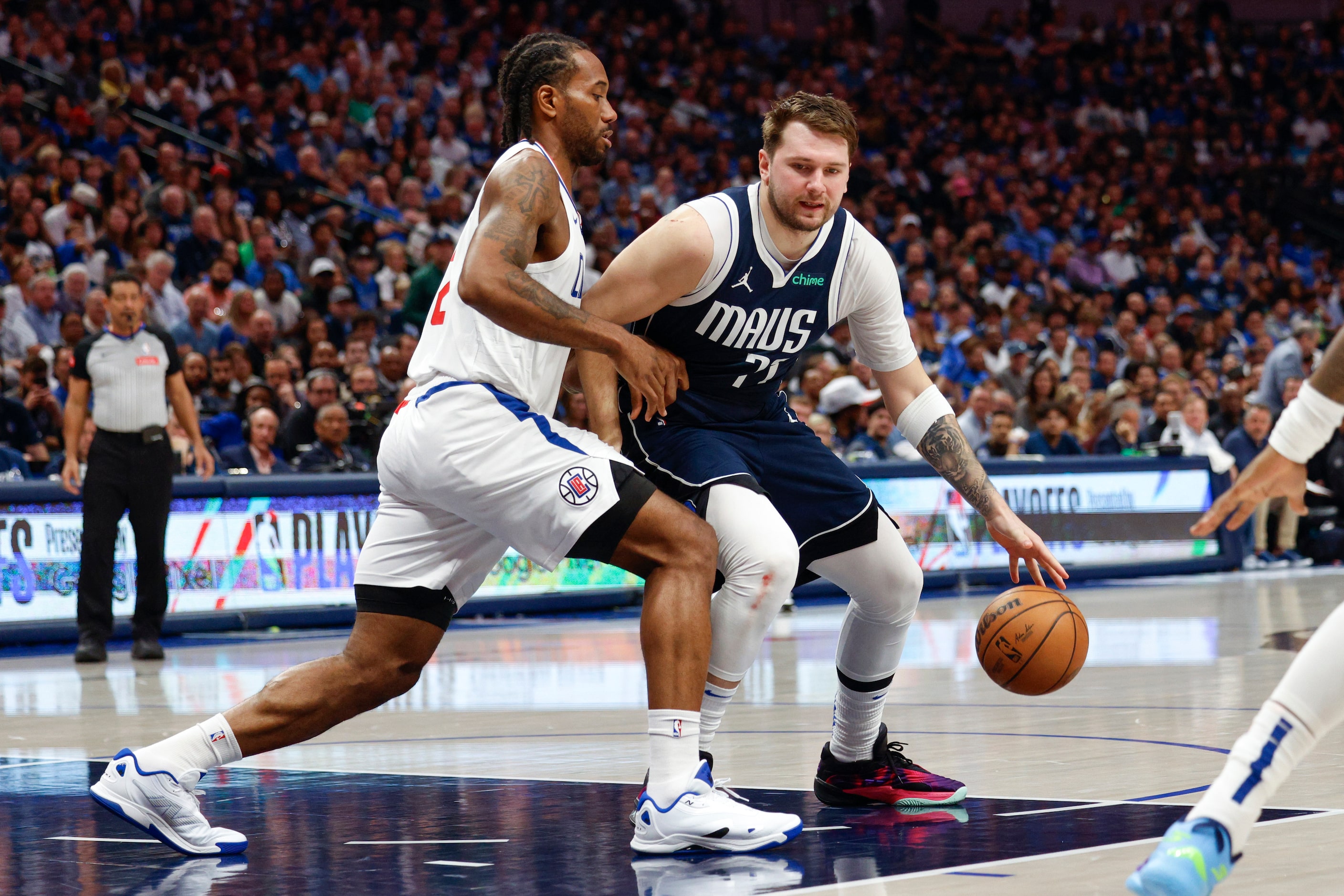 LA Clippers forward Kawhi Leonard (2) defends Dallas Mavericks guard Luka Doncic (77) in the...