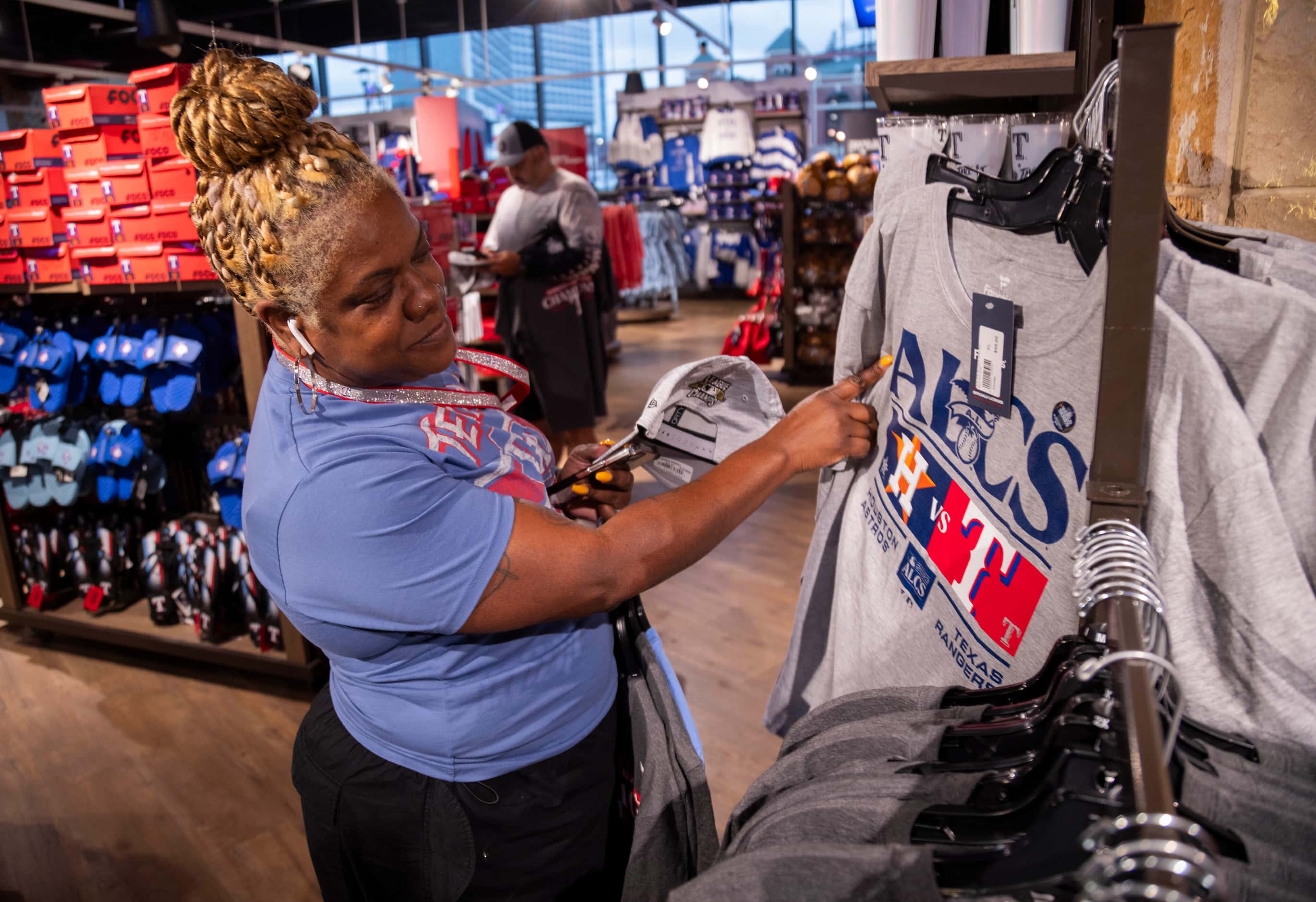 Rangers fan Nakisha Ortiz looks at American League Championship Series shirts on sale at the...