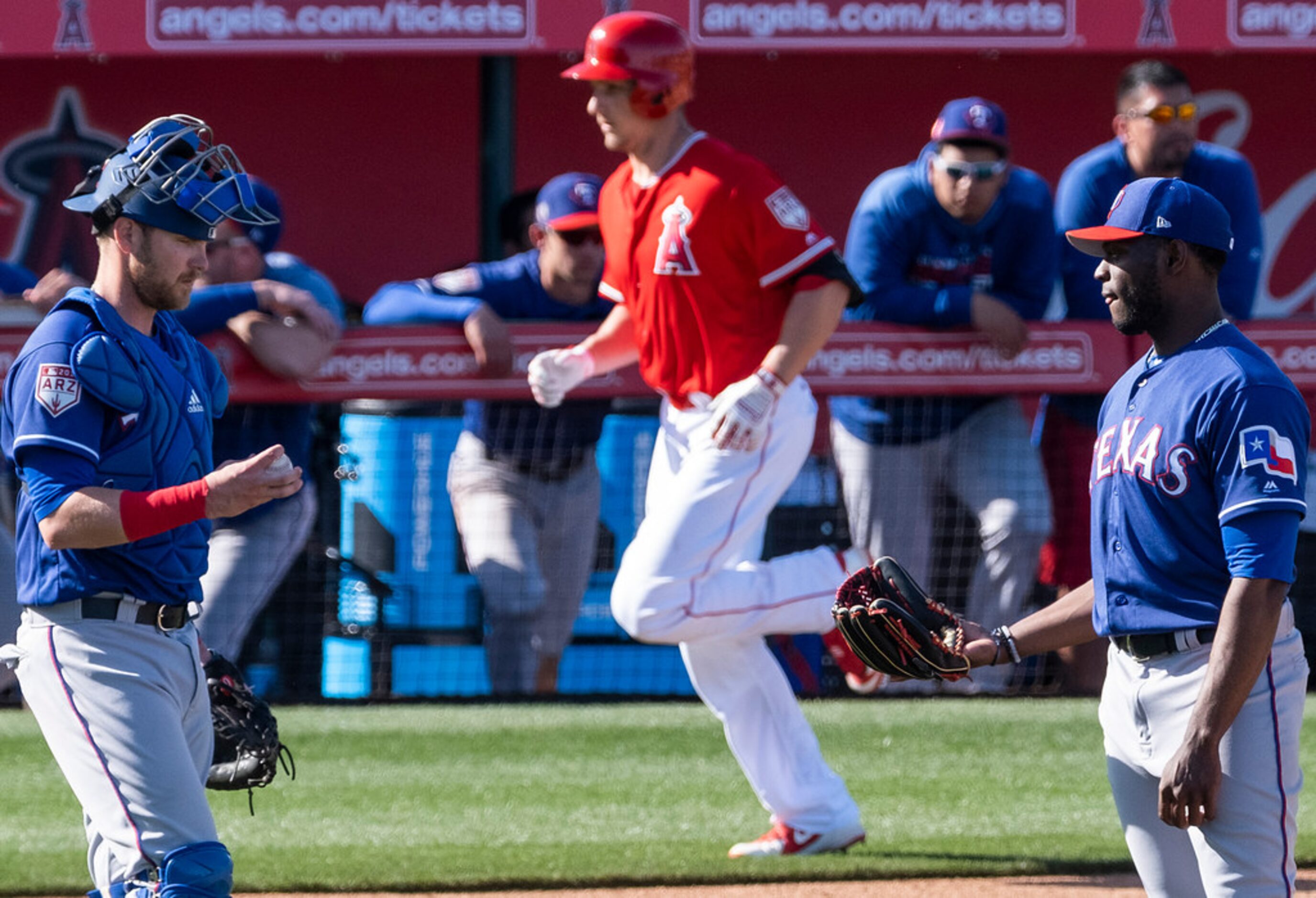 Texas Rangers pitcher CD Pelham gets a visit from catcher Jett Bandy as Los Angeles Angels...