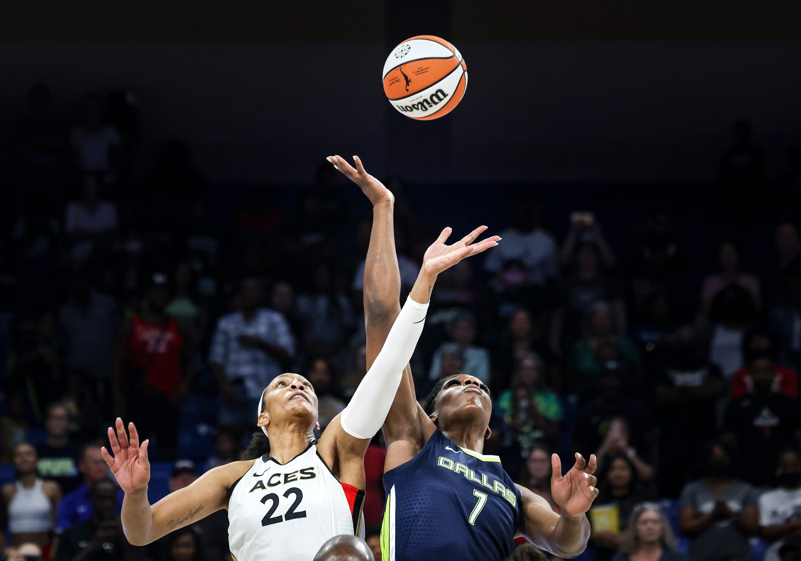 Las Vegas Aces forward A'ja Wilson (22) and Dallas Wings center Teaira McCowan (7) jump for...