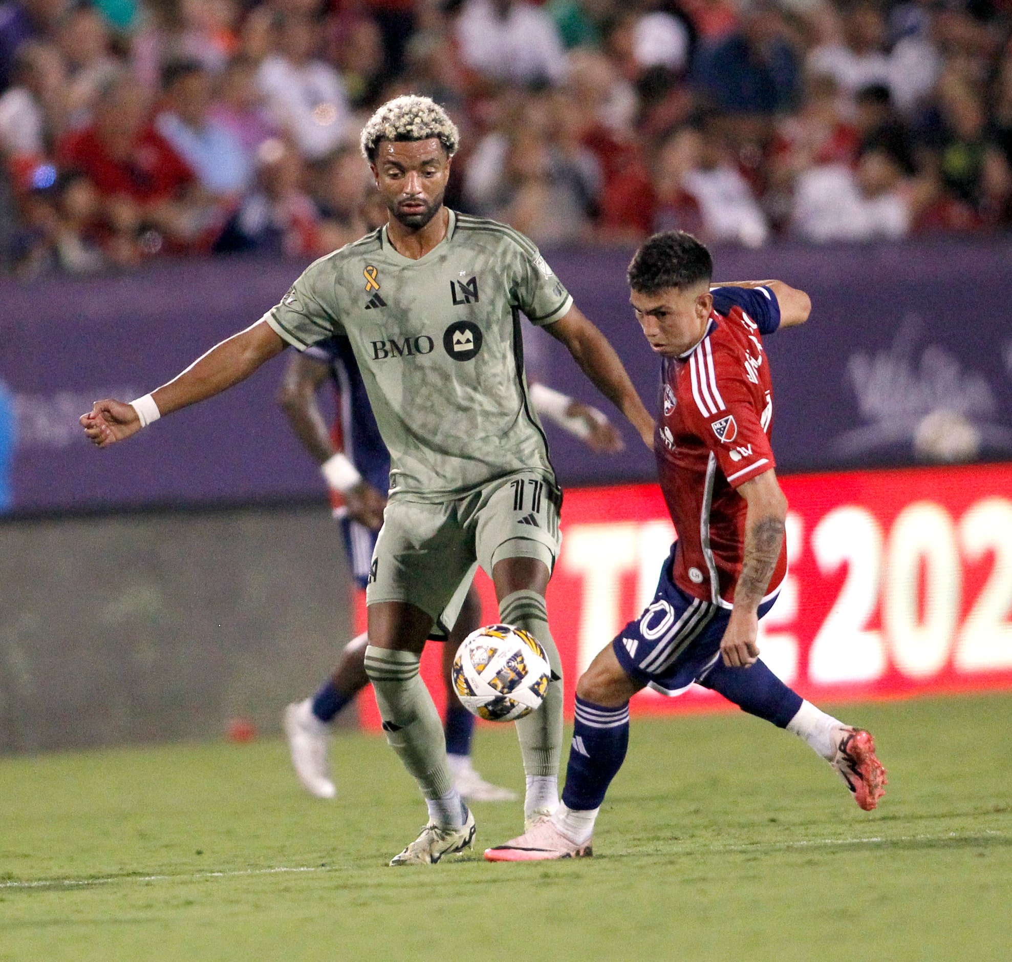 FC Dallas midfielder Alan Velasco (20), right, challenges LAFC midfielder Timothy Tillman...