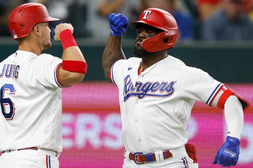 Texas Rangers third baseman Josh Jung (6) celebrates after right fielder Adolis Garcia (53)...