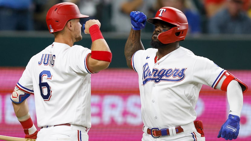 Texas Rangers third baseman Josh Jung (6) celebrates after right fielder Adolis Garcia (53)...