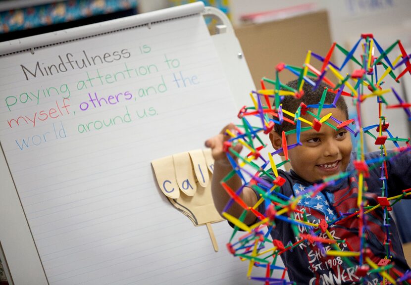 Henry Zavala uses a "breathing ball" as he and classmates take part in mindfulness exercises...