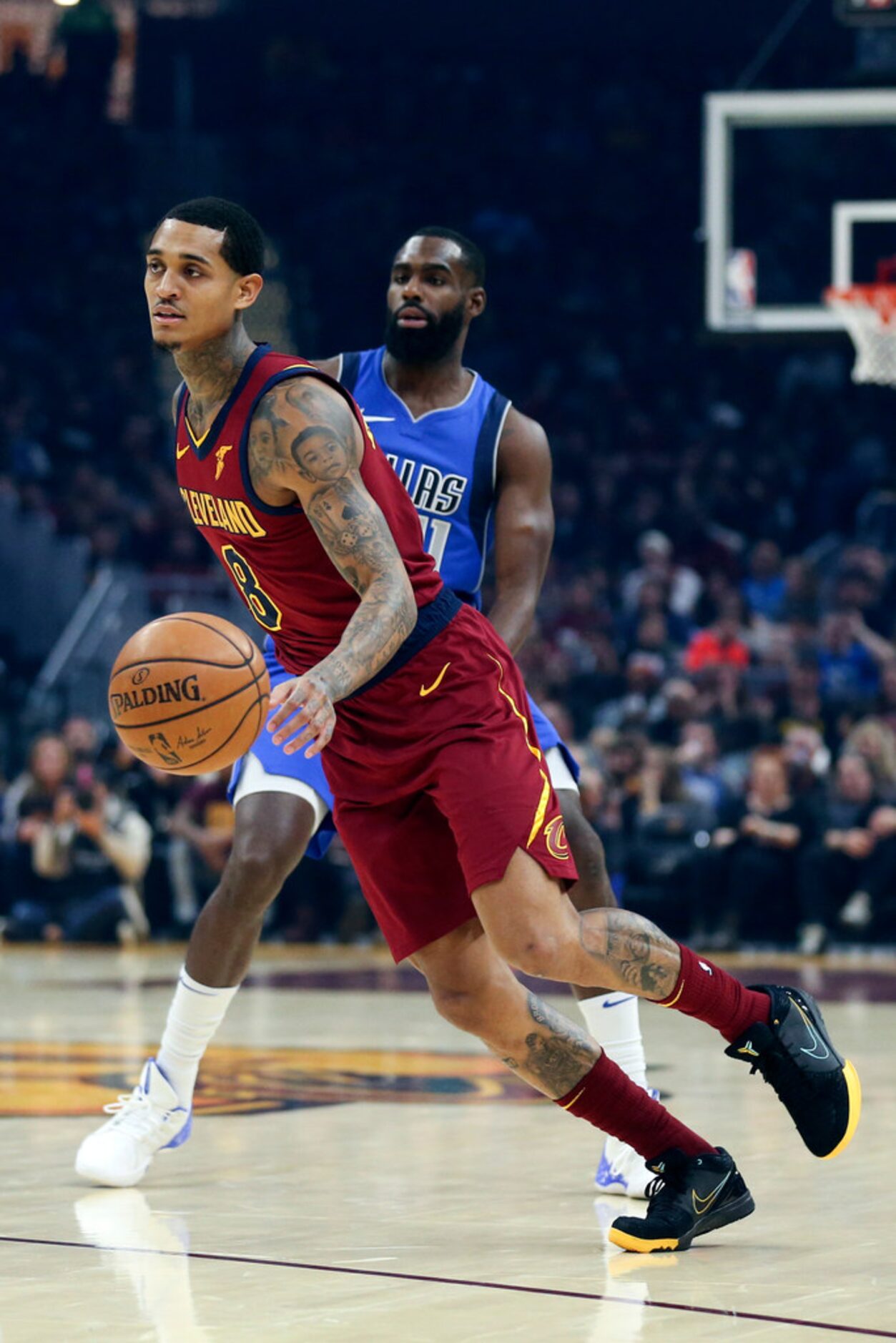 Cleveland Cavaliers' Jordan Clarkson (8) drives around Dallas Mavericks' Tim Hardaway Jr. in...