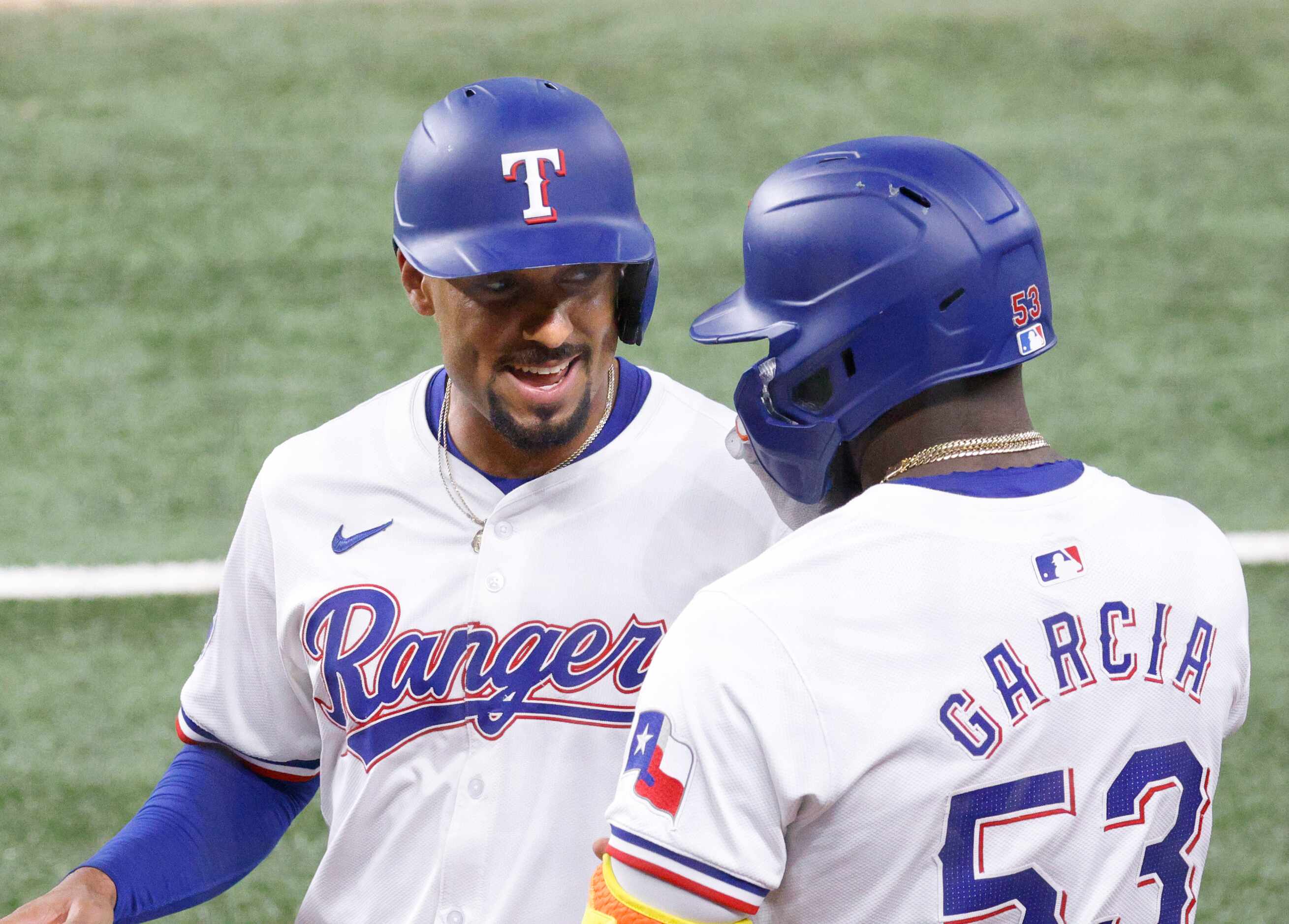 Texas Rangers second base Marcus Semien (2) talks with Texas Rangers outfielder Adolis...