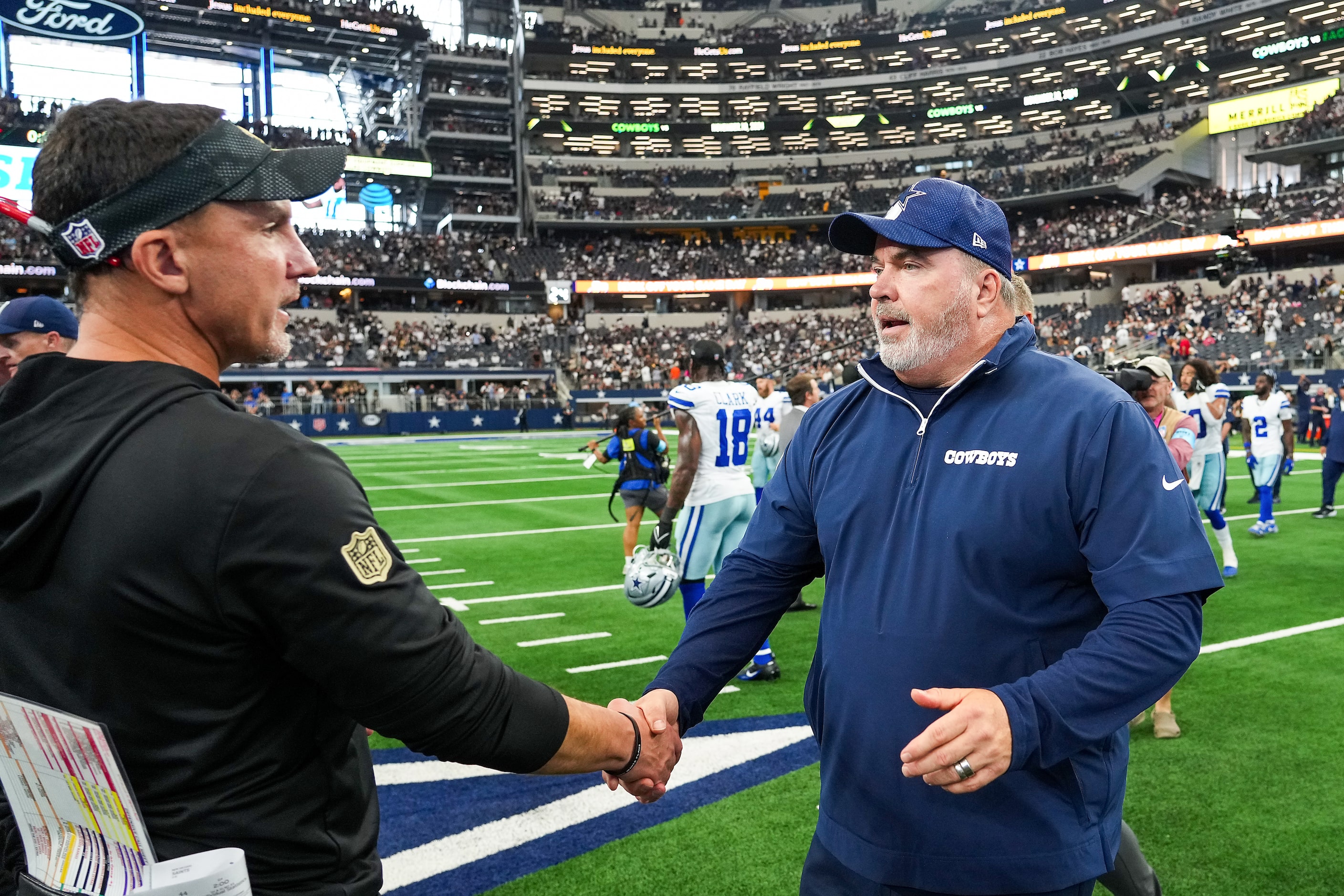 Dallas Cowboys head coach Mike McCarthy shakes hands with New Orleans Saints head coach...