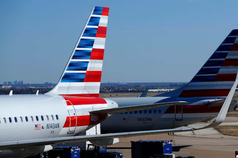 American Airlines planes move about the tarmac at Terminal A at Dallas-Fort Worth...