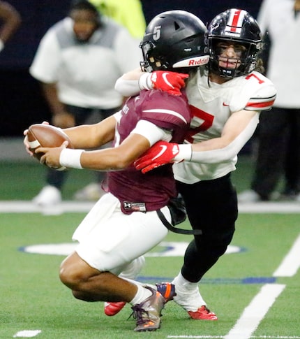 Mansfield Timberview High School quarterback Jaeden Marshall (5) is taken down by Lovejoy...