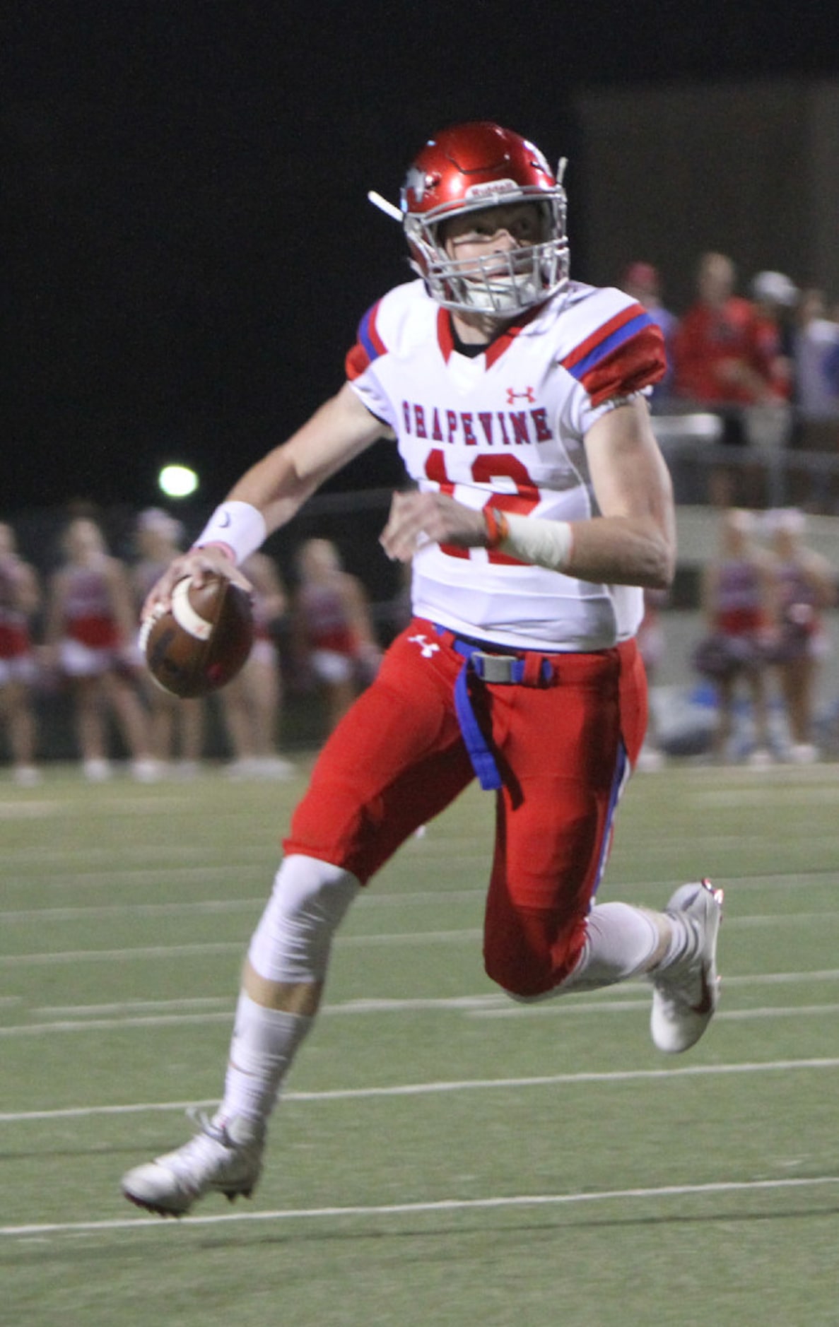 Grapevine quarterback Alan Bowman (12) rolls out before launching a touchdown pass during...