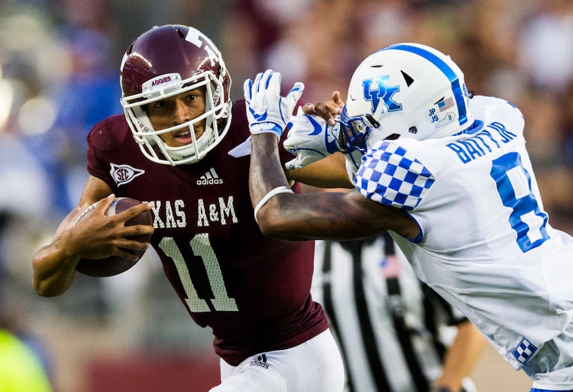 Texas A&M Aggies quarterback Kellen Mond (11) stiff arms Kentucky Wildcats cornerback...