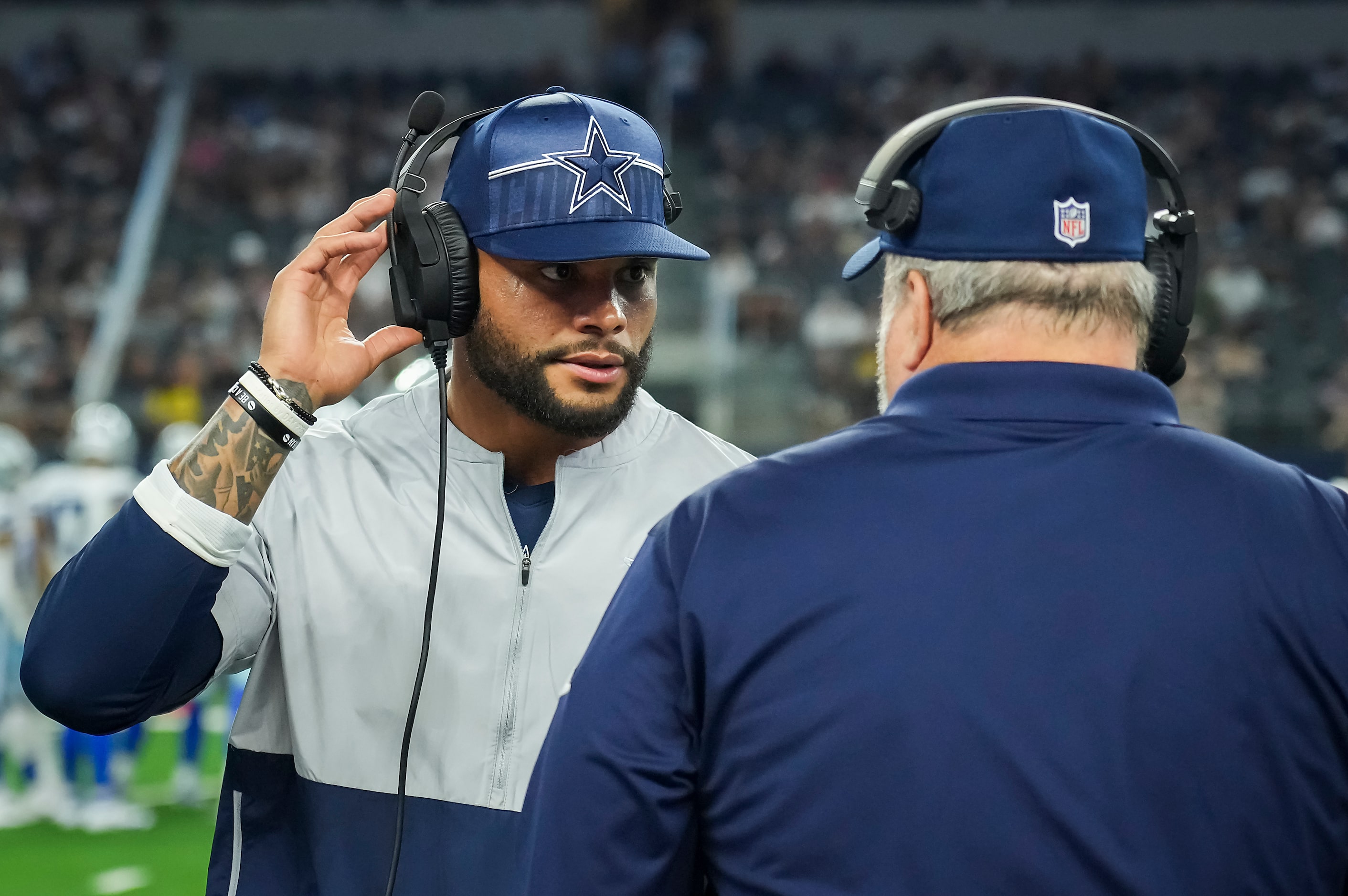 Dallas Cowboys quarterback Dak Prescott talks with head coach Mike McCarthy as he calls...