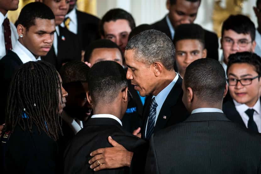 President Barack Obama, center, speaks with teenagers involved in the Becoming a Man program...