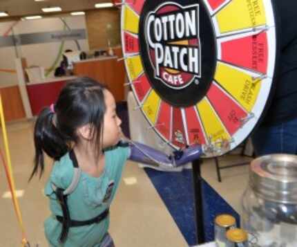  Gianna Polus,9, spins the prize wheel.