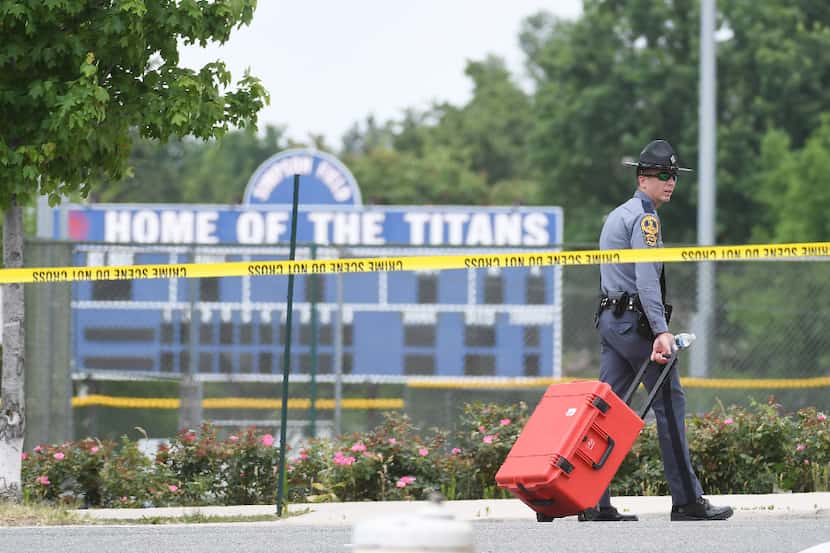 A police officer walks next to Eugene Simpson Stadium Park. MUST CREDIT: Washington Post...