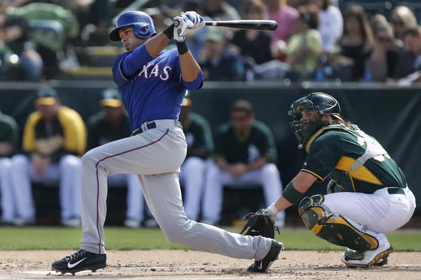 Texas outfielder Alex Rios is pictured hitting in the first inning during the Texas Rangers...