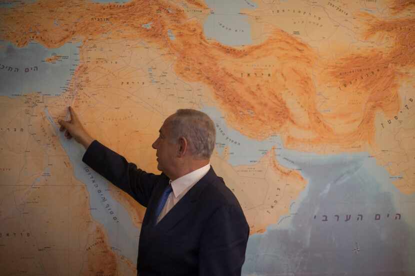 Prime Minister Benjamin Netanyahu by the floor-to-ceiling map with Israel at its center, at...