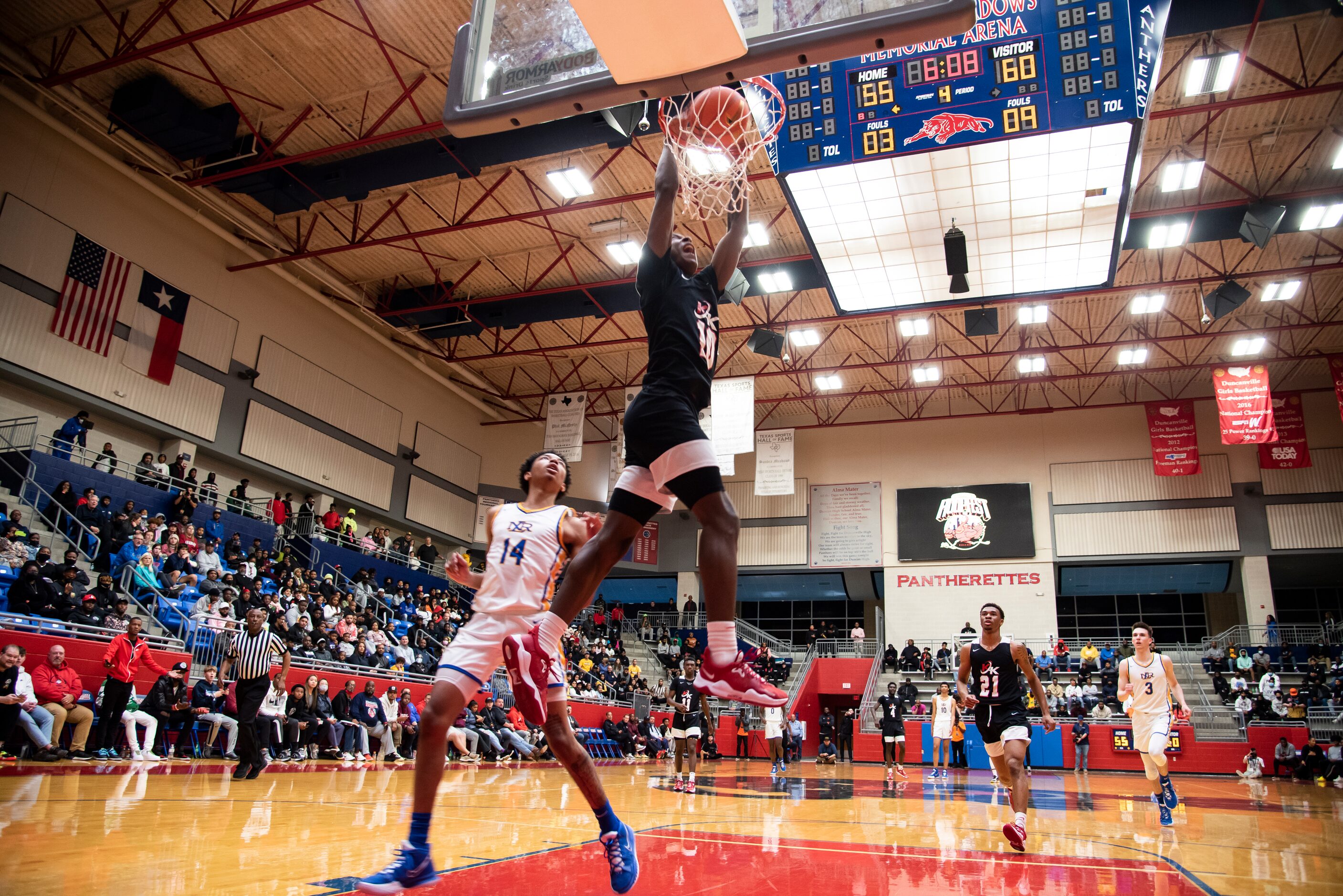 Kimball senior Trey Clayton (10) goes up for a slam dunk during Kimball's Thanksgiving...