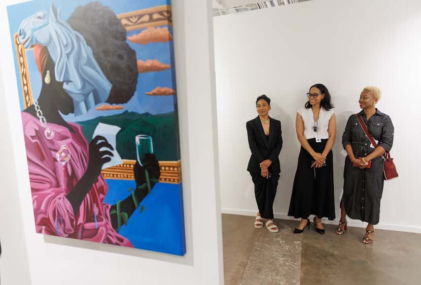 Artists Jessica Vollrath (left) and Abi Salami (right) help gallerist Valerie Gillespie...