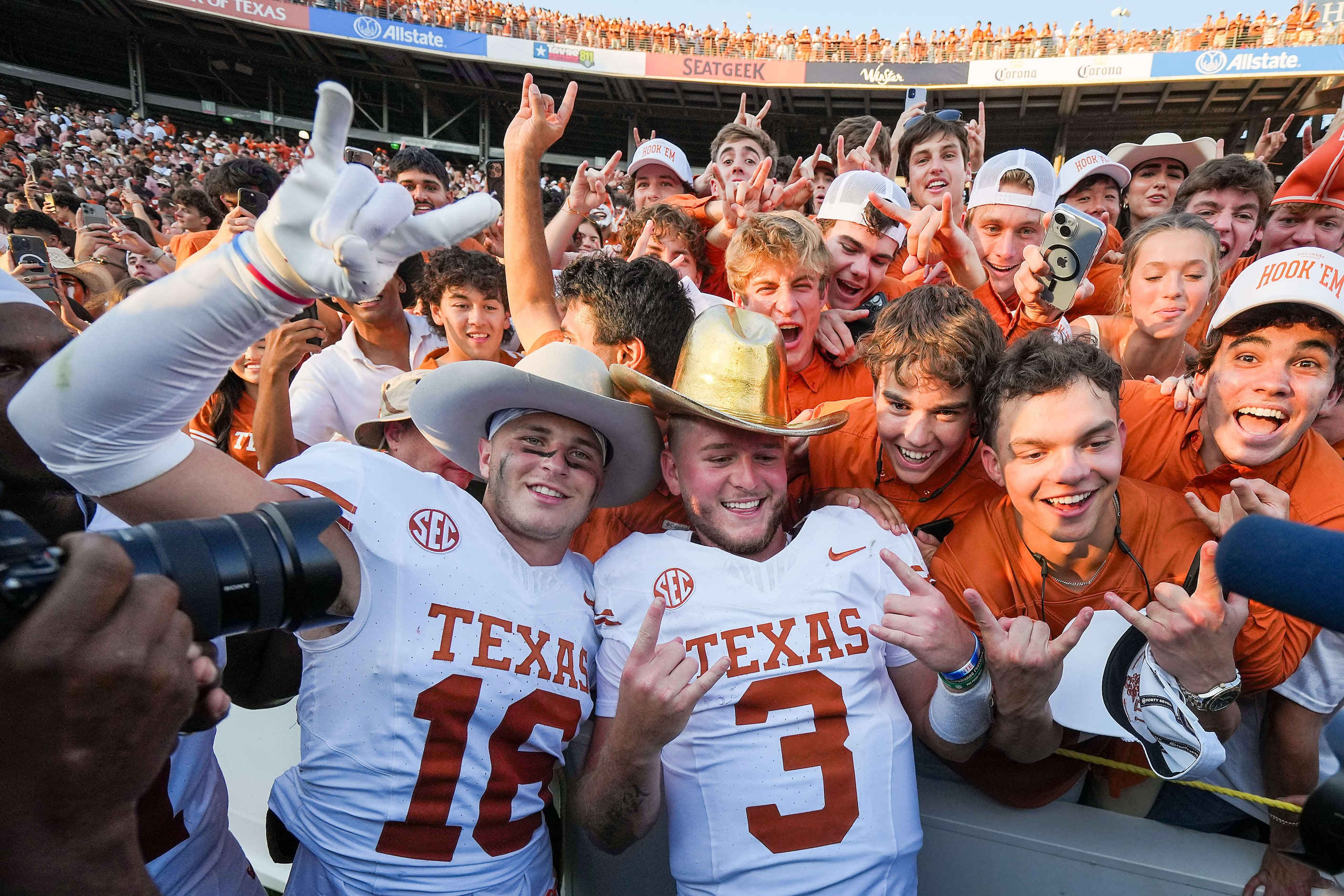 Texas quarterback Quinn Ewers (3) wears the Golden Hat Trophy as he celebrates with...